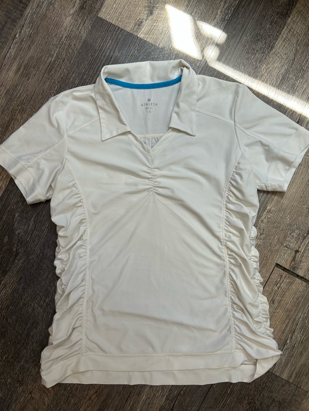EUC Athleta white Birdie polo shirt featuring ruched side detailing